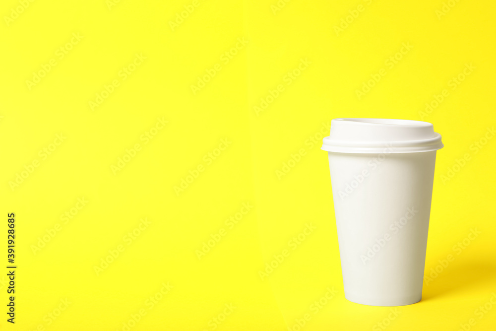 Takeaway paper coffee cup on yellow background. Space for text Takeaway paper coffee cup on yellow background. Space for text
