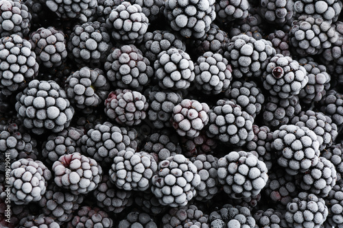 Tasty frozen blackberries as background, top view