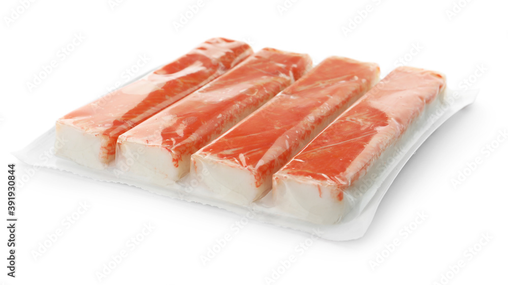 Delicious crab sticks in plastic packaging isolated on white Delicious crab sticks in plastic packaging isolated on white