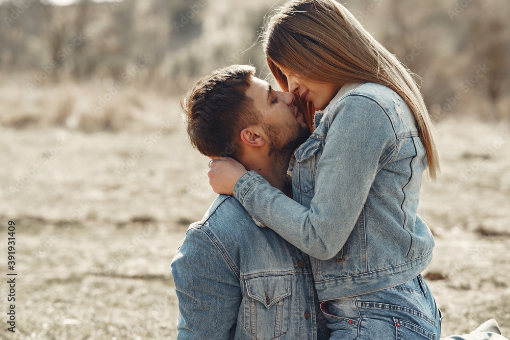 Fototapeta premium Woman in a jeans clothes. Couple in a spring forest.