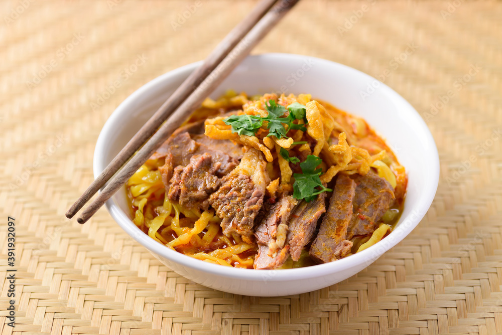 Northern Thai food (Khao Soi), Spicy curry noodles soup with beef in a bowl and chopsticks