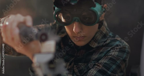 Female craftsman working with grinder at workshop. Close up footage of craftswoman grinding stone. 