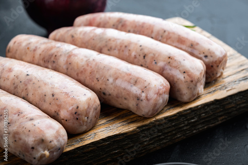 Traditional raw sausages, on black background