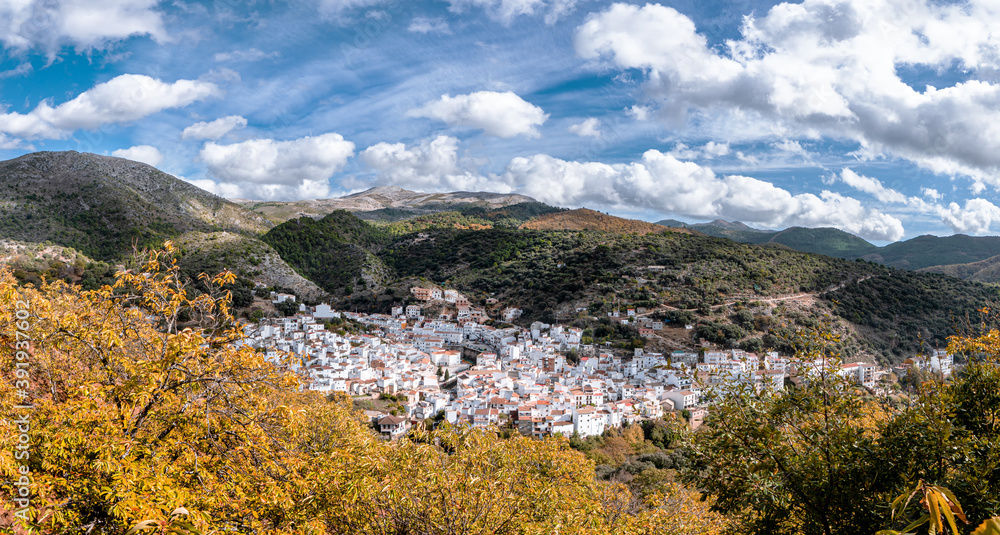 View of the mountains of Serrania de Ronda, Igualeja village and the chestnut forest in autumn. Trekking route, scenic, around the villages of Parauta, Cartajima and Igualeja in Malaga, Spain