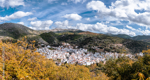 View of the mountains of Serrania de Ronda, Igualeja village and the chestnut forest in autumn. Trekking route, scenic, around the villages of Parauta, Cartajima and Igualeja in Malaga, Spain photo