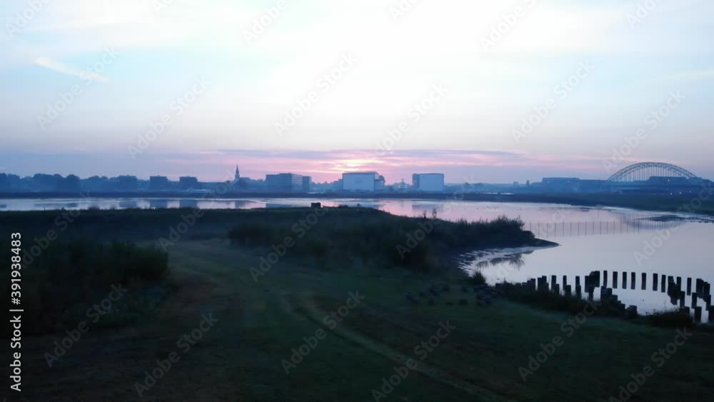 beautiful drone shot at the dutch foggy nature with a city skyline at the background during sunrise beautiful drone shot at the dutch foggy nature with a city skyline at the background during sunrise