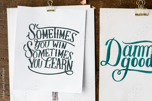 Hand lettering of motivation quote on sketch sheets