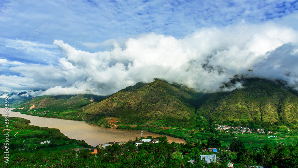 The river on the mountain, the white clouds on the top of the mountain, the beautiful natural scenery