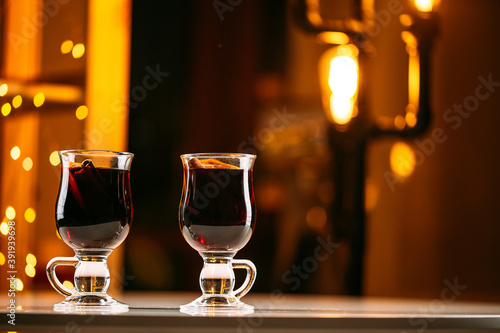 Two glass mugs of glintwine with blurry lights