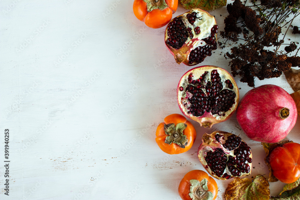 Persimmons and pomegranate fruits. Board. Persimmons and pomegranate fruits. Board.