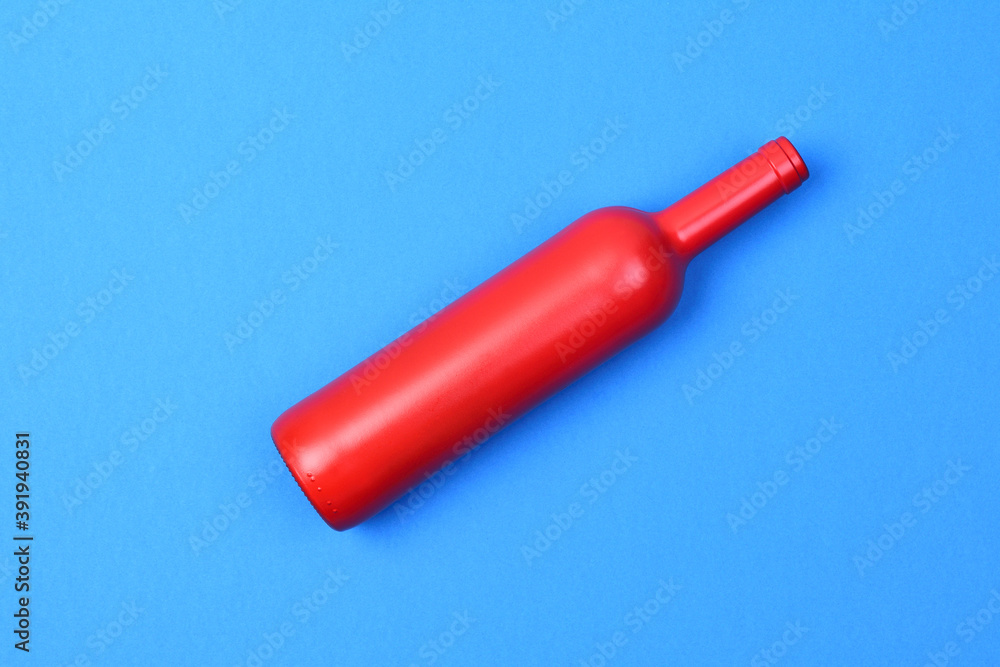 red glass bottle on blue background red glass bottle on blue background