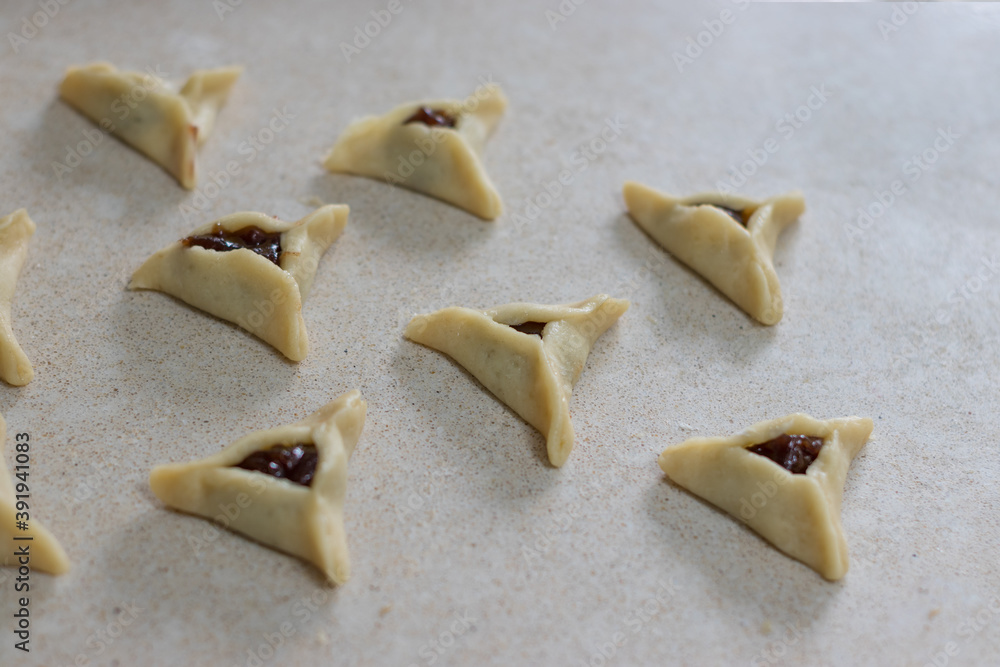 Hamantaschen. (ozenei haman) Triangular pastry made of crispy dough, stuffed with poppy, halva or chocolate. For the Jewish holiday of Purim. Handmade in the middle of preparation, 