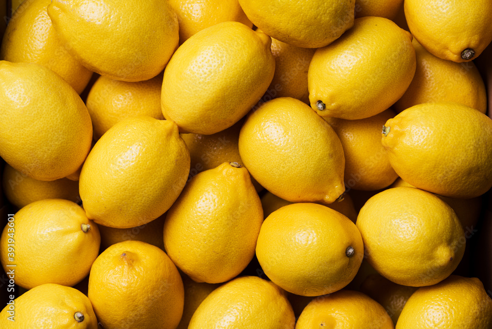 Fresh lemon background. Top view. Citrus fruits. Vitamins for health. Box of yellow lemons. Liposomal vitamin C Fresh lemon background. Top view. Citrus fruits. Vitamins for health. Box of yellow lemons. Liposomal vitamin C