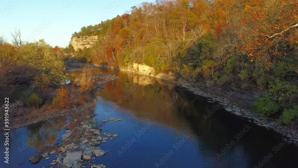 Aerial shot traveling down Elkhorn Creek in the fall cliff reflecting off the water Aerial shot traveling down Elkhorn Creek in the fall cliff reflecting off the water