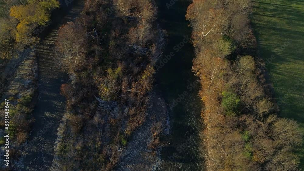 Aerial shot rising from beautiful creek revealing farmhouse and beautiful countryside in the distance