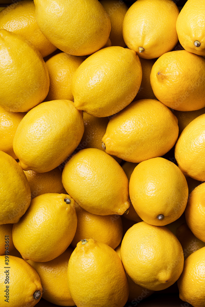 Fresh lemon background. Top view. Citrus fruits. Vitamins for health. Box of yellow lemons. Liposomal vitamin C Fresh lemon background. Top view. Citrus fruits. Vitamins for health. Box of yellow lemons. Liposomal vitamin C