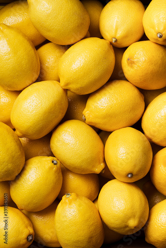 Fresh lemon background. Top view. Citrus fruits. Vitamins for health. Box of yellow lemons. Liposomal vitamin C