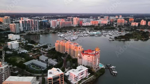 Skyline drone footage of beautiful Sarasota, Florida during sunset. This footage captures the bay area of Sarasota and shows Golden Gate Point and the Marina. 60 fps. photo