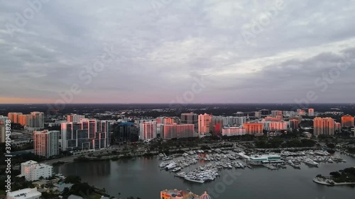 Skyline drone footage of beautiful Sarasota, Florida during sunset. This footage captures the bay area of Sarasota and shows Golden Gate Point and the Marina. 60 fps. photo