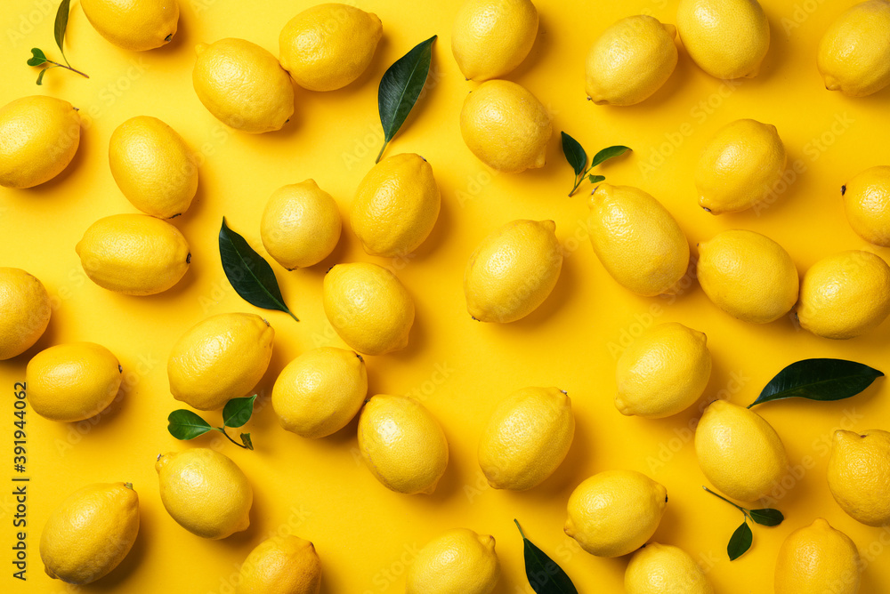 Immune system booster. Fresh lemons pattern on yellow background. Copy space. Top view. Flat lay. Citrus fruits. Vitamins for health. Liposomal vitamin C. Lemon for vegan, vegetarian alkaline diet Immune system booster. Fresh lemons pattern on yellow background. Copy space. Top view. Flat lay. Citrus fruits. Vitamins for health. Liposomal vitamin C. Lemon for vegan, vegetarian alkaline diet