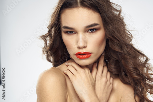 Beautiful woman with drawn swords bright makeup glamor close-up light background