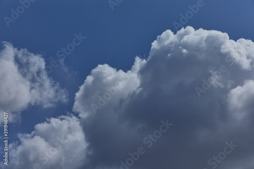 Atmospheric blue sky with cumulated clouds. Background with thick white clouds for Photoshop.