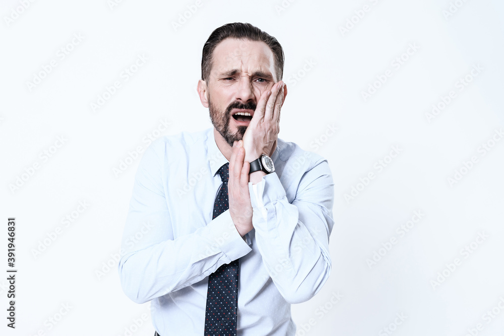 Man holds his jaw and suffers from severe pain. Man holds his jaw and suffers from severe pain.