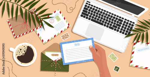 Envelopes, letters, postcards and a laptop on the table. Envelope in hand. Workspace and table top view. Woman sends a postcard in flat hand drawn style. Vector stock illustration.