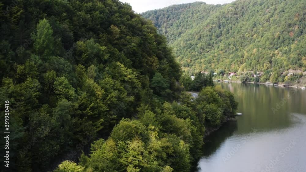 Aerial shot of a rally car race on a river valley. Summer mountains Aerial shot of a rally car race on a river valley. Summer mountains