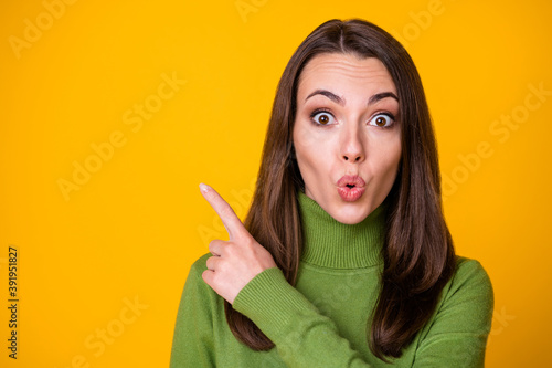 Close-up portrait of attractive amazed stunned girl demonstrating copy space pout lips isolated over vibrant yellow color background © deagreez