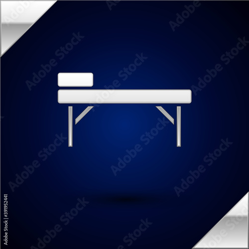Silver Massage table icon isolated on dark blue background. Vector.