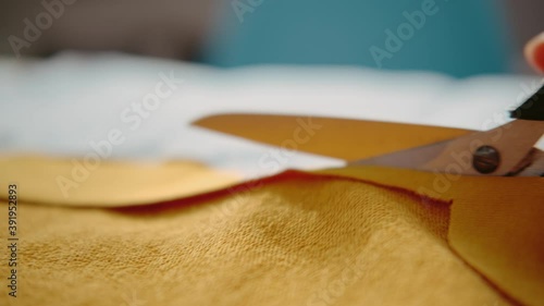 Wallpaper Mural Cut the bright yellow fabric with scissors, close-up. Torontodigital.ca