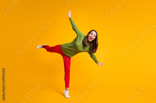Full length body size view of nice overjoyed cheerful girl jumping having fun isolated on bright yellow color background