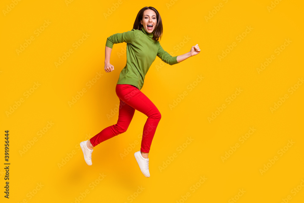 Full length profile photo of crazy lady jump up rush wear casual pullover shoes red trousers isolated yellow color background