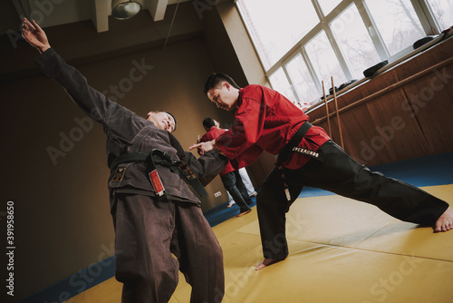 A man in a red kimono knocks down rival. 