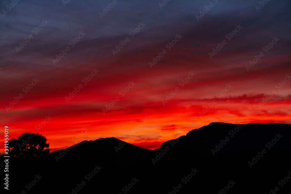 Stylish autumn red sunset sky over the mountains. Sunset background in crimson shades for the website and photoshop. Stylish autumn red sunset sky over the mountains. Sunset background in crimson shades for the website and photoshop.