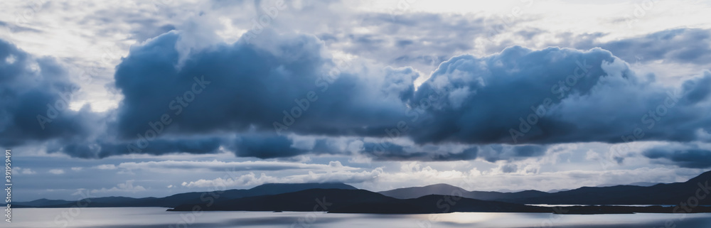 picturesque view on sea coastline and cloudy sunset sky
