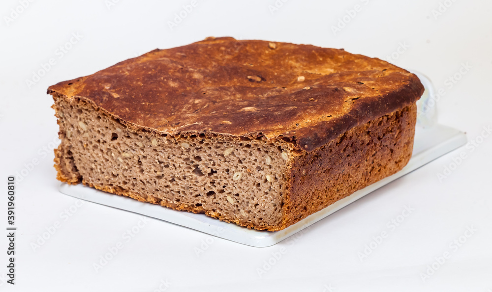 Rye homemade bread on a ceramic cutting Board on white background Rye homemade bread on a ceramic cutting Board on white background