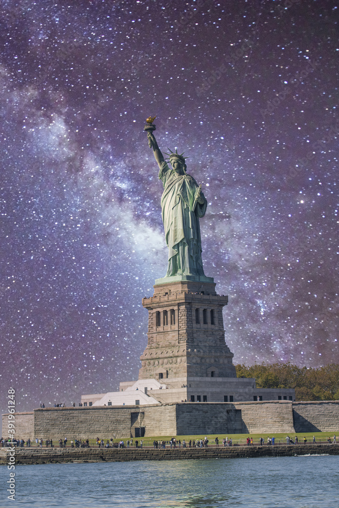 Fototapeta premium The Statue of Liberty under a starry night, New York City - USA