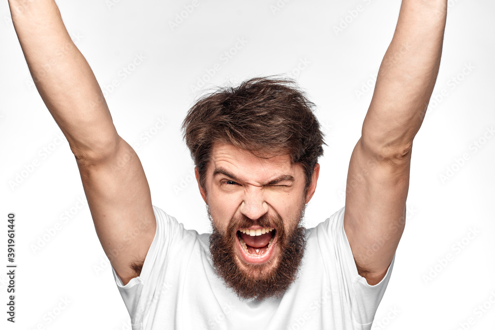 cheerful emotional bearded man gesturing with his hands close-up light background cheerful emotional bearded man gesturing with his hands close-up light background