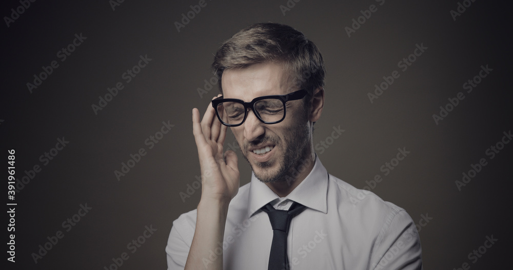 Stressed businessman with headache Stressed businessman with headache
