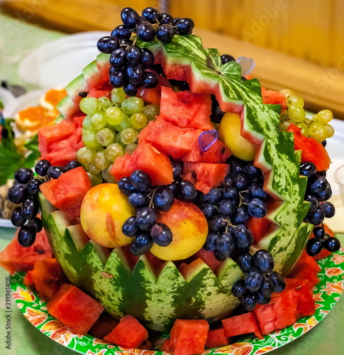 A plate of fruit in a carved watermelon close-up