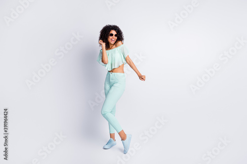 Full length body size photo of cheerful funky black skinned girl wearing sunglass dancing at party isolated on grey color background