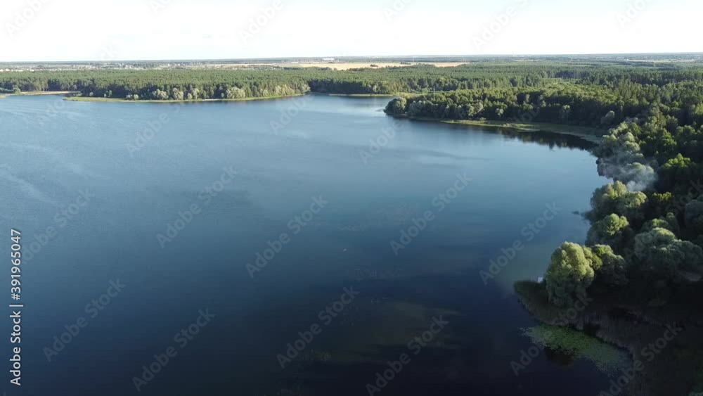 Top view of the lake in a deep fir forest. Taken from a quadcopter Top view of the lake in a deep fir forest. Taken from a quadcopter