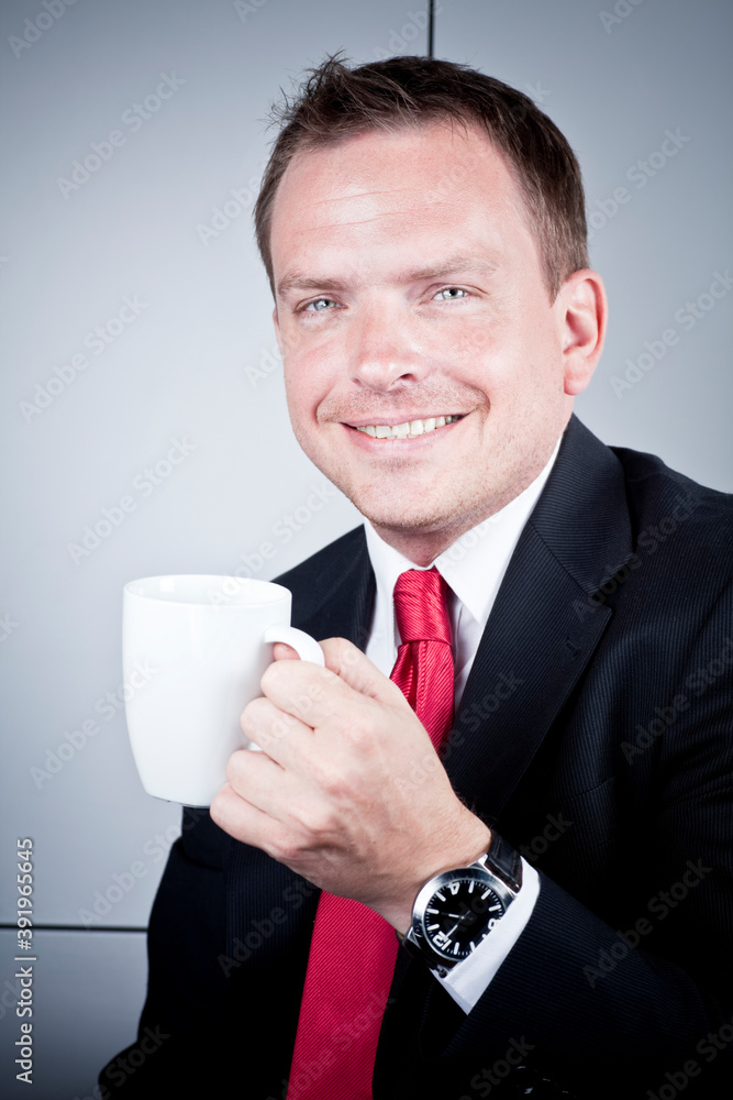 Portrait of a happy businessman with coffee cup, looking at camera and smiling. Portrait of a happy businessman with coffee cup, looking at camera and smiling.