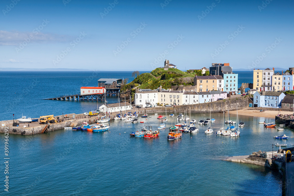 Tenby Harbour which is a seaside resort town in Pembrokeshire Wales UK and is a popular travel destination tourist attraction landmark, stock photo image