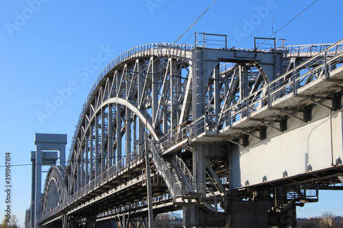 Close-up of the arched span of the railway two-track bridge