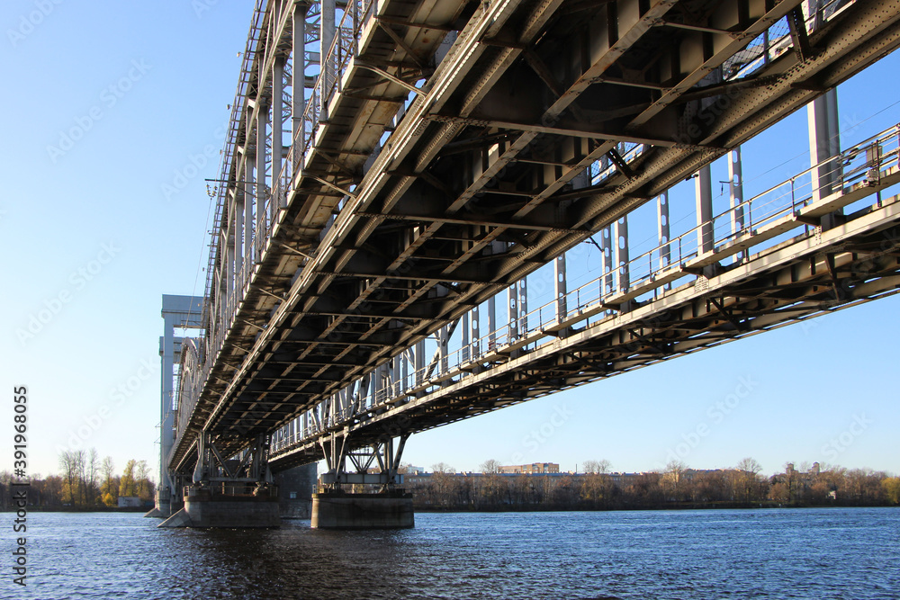 View from under the bridge on the two tracks of the railway bridge with four arched spans and a lifting center span