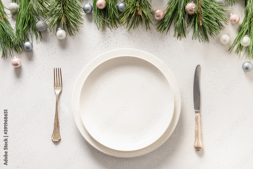 Christmas table setting with white holiday elegant decorations on white table. View from above. Christmas table setting with white holiday elegant decorations on white table. View from above.