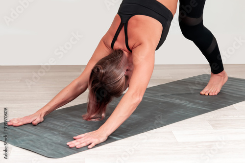 Athletic middle aged woman doing exercises..Hatha yoga